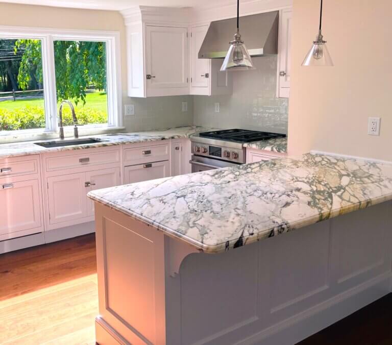 breccia countertops,antic green spanish metro splash and naturasl walnut floor